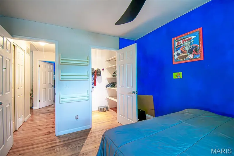 BEDROOM # 3 – With Walk-in closet & a niche for Dresser  - featuring wood-finish flooring, a ceiling fan with integrated lighting, and a window with blinds — 13261 COCHERO Drive, Chesterfield, MO 63141
