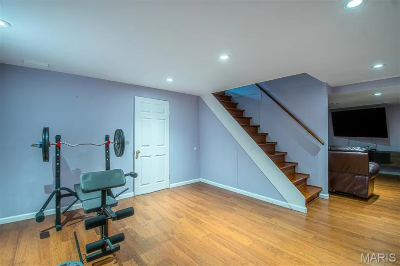 LOWER-LEVEL REC/R # 1 - featuring wood-finish flooring, recessed lighting, and a white paneled door — 13261 COCHERO Drive, Chesterfield, MO 63141