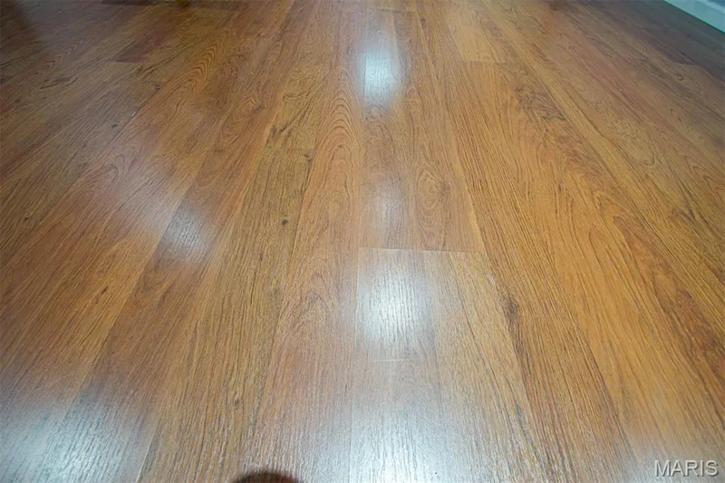 LOWER-LEVEL - Wood-finish flooring with a warm brown tone and visible grain patterns — 13261 COCHERO Drive, Chesterfield, MO 63141