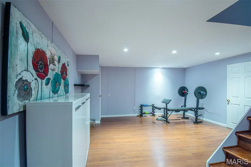 LOWER-LEVEL REC/R # 1 - featuring wood-finish flooring, recessed lighting, and a white paneled door — 13261 COCHERO Drive, Chesterfield, MO 63141