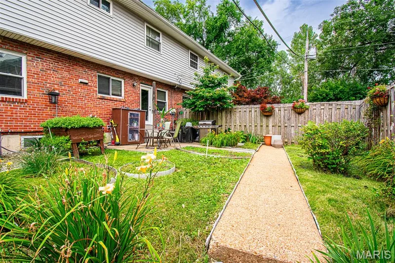 FENCED BACKYARD - Featuring a concrete patio, a pathway, and established plantings — 13261 COCHERO Drive, Chesterfield, MO 63141