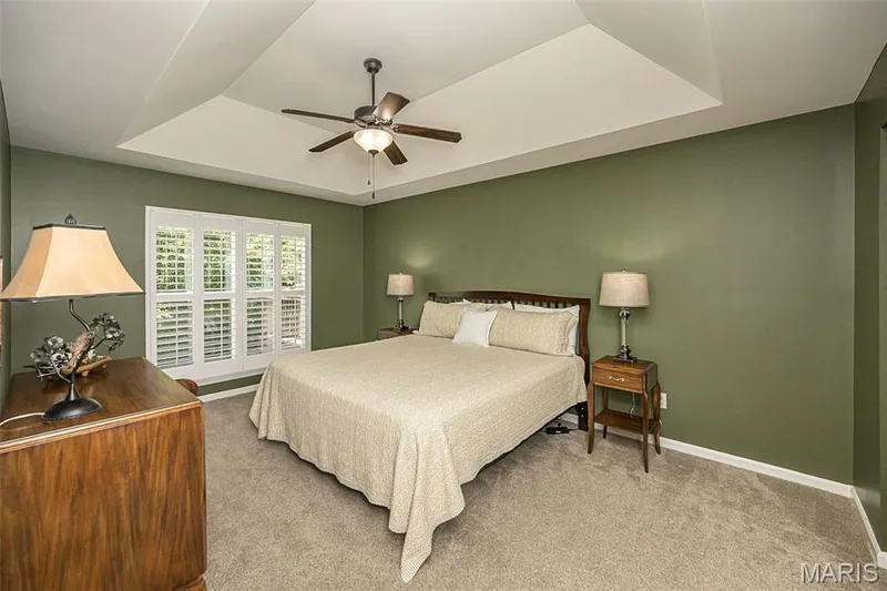 The primary bedroom is spacious and has a little flair. The coffered ceiling is one of the seller's favorite bedroom features. She also really loves the plantation shutters. — 249 Belmonte Circle, O'Fallon, MO 63368