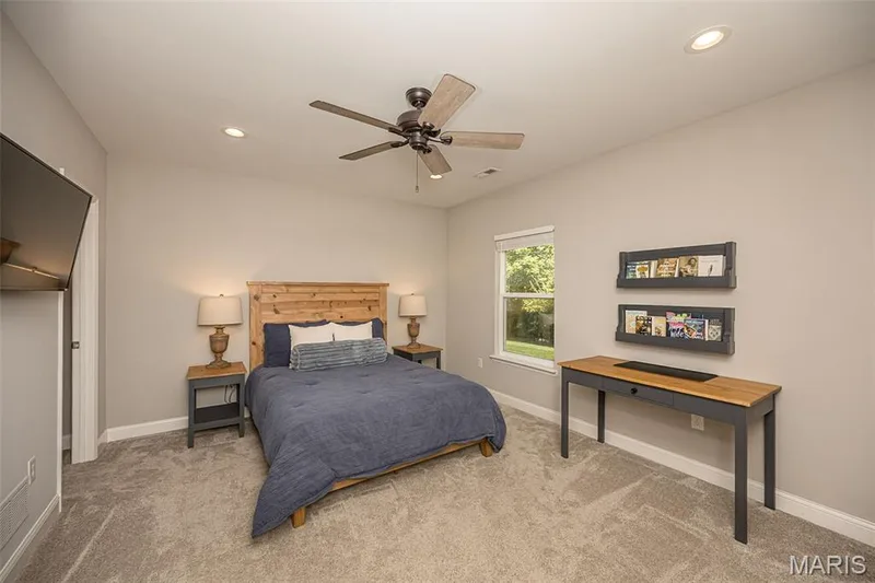 The third bedroom, located in the lower level, offers can lights, a large walk in closet, and a door directly connected to the bathroom. This room is very large and could easily be set up as a home office while still offering room for a guest suite. — 249 Belmonte Circle, O'Fallon, MO 63368