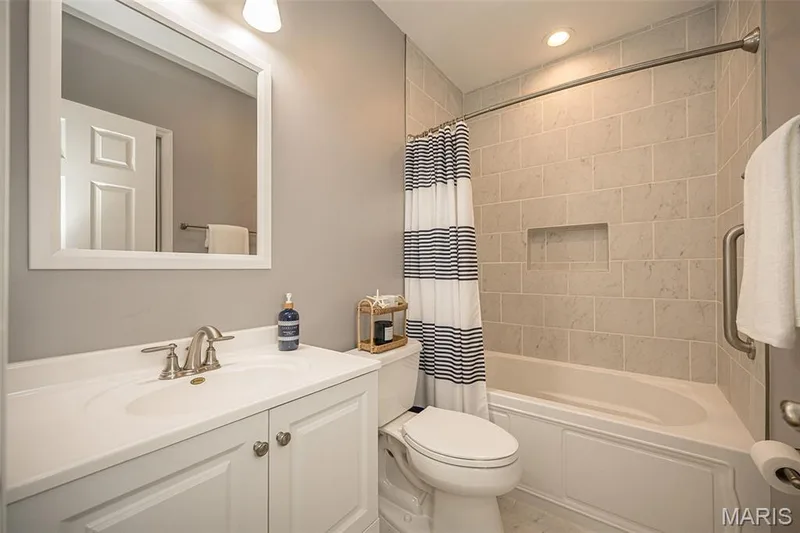 The lower level bathroom is spa like! It has a deep soaking tub and a tile surround, a comfort height toilet and a beautiful white vanity. The bathroom also has 2 access doors, one from the hall and one from the bedroom. — 249 Belmonte Circle, O'Fallon, MO 63368