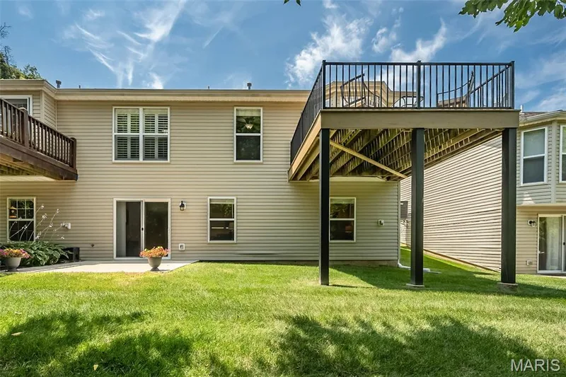 Backyard view of the home. The space under the deck offers opportunities for you to put your touch on this space. — 249 Belmonte Circle, O'Fallon, MO 63368
