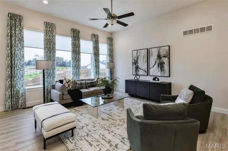 Great Room with a view of the window wall and ceiling fan — 401 Farmhouse Drive, O'Fallon, MO 63385