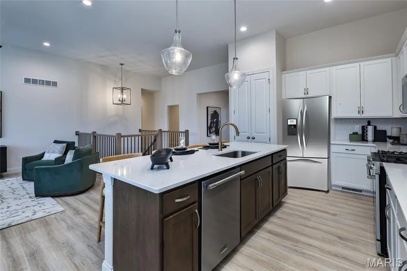 Kitchen are with a view of the Great Room and stairwell — 401 Farmhouse Drive, O'Fallon, MO 63385