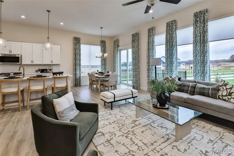 Great Room with a view of the window wall, sliding door to deck and Breakfast area — 401 Farmhouse Drive, O'Fallon, MO 63385