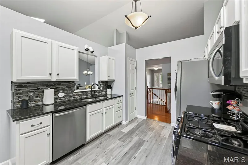 Spacious kitchen with luxury vinyl plank flooring. — 306 Villa Tuscany Court #10B, O'Fallon, MO 63366