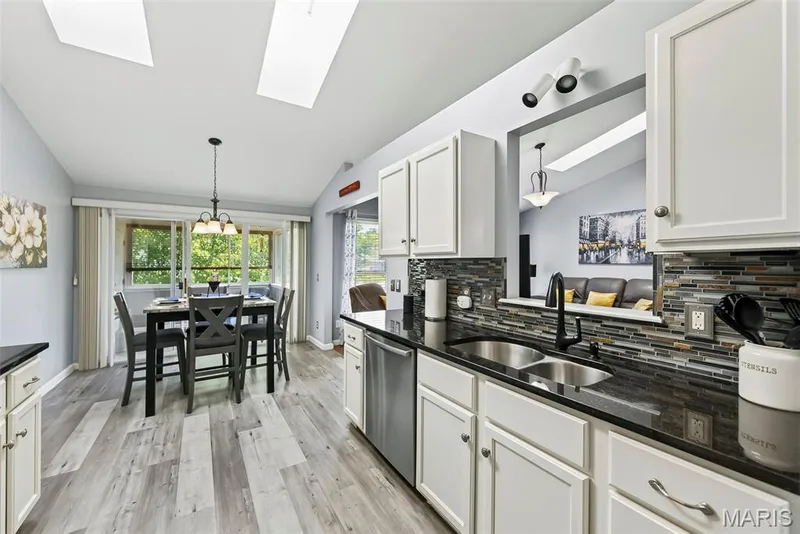 Kitchen view into breakfast area & 3 season room. — 306 Villa Tuscany Court #10B, O'Fallon, MO 63366