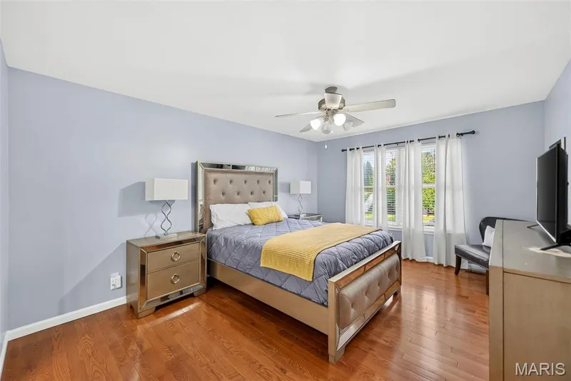 Large primary bedroom with hardwood flooring. — 306 Villa Tuscany Court #10B, O'Fallon, MO 63366