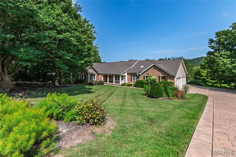 Stamped Driveway leading to oversized 3 Car Garage — 17507 Summit View Place Cove, Glencoe, MO 63038