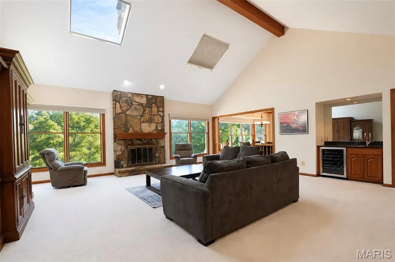The vaulted Great Room, looks out over the Backyard and is adjacent to the Breakfast Room.  Cozy Gas Fireplace and Skylights. — 17507 Summit View Place Cove, Glencoe, MO 63038