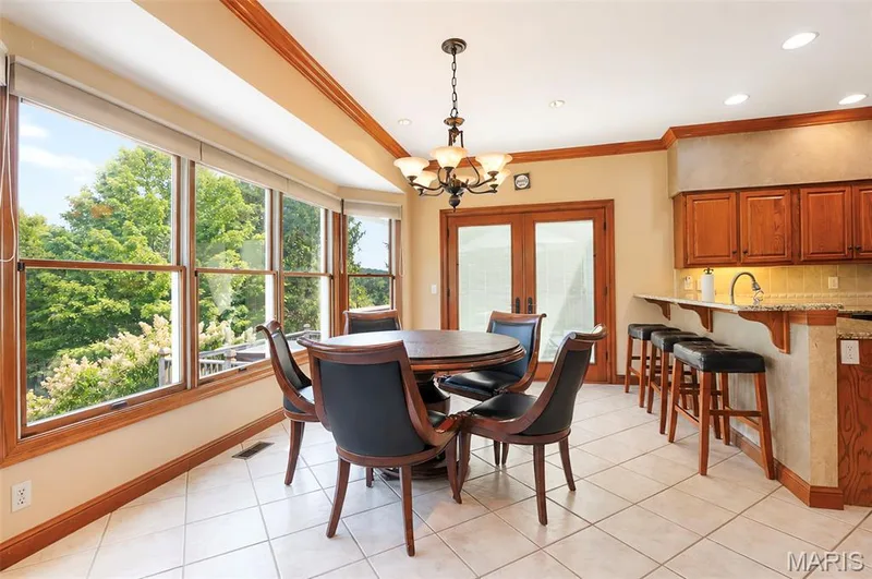Large windows overlooking the backyard courtyard patio.Ceramic tile flooring and crown mold.  Breakfast bar adds additional seating. — 17507 Summit View Place Cove, Glencoe, MO 63038