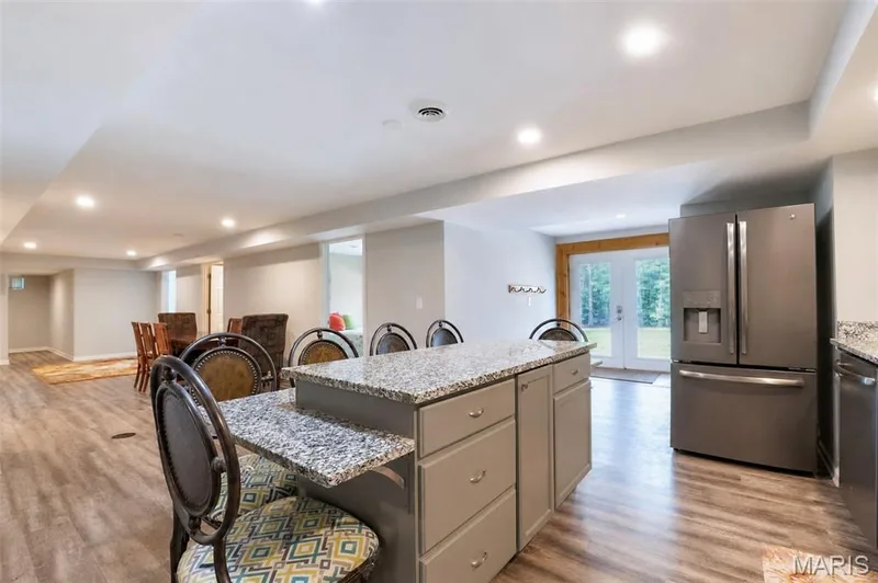 Kitchen features Granite Counters and brushed chrome appliances. — 17507 Summit View Place Cove, Glencoe, MO 63038