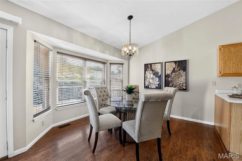 Large breakfast room adjacent to the family room - to the left is a door that leads to the rear yard.  Note the large bay window. — 582 Prentice Drive, St Peters, MO 63376