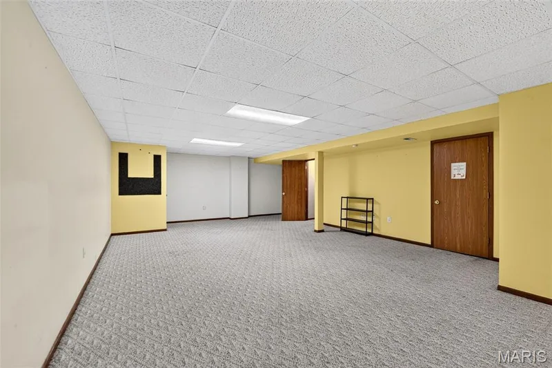 Plenty of room for the kiddos to play or have a nice theatre room.  The door leads to the spacious storage and the laundry area. — 582 Prentice Drive, St Peters, MO 63376