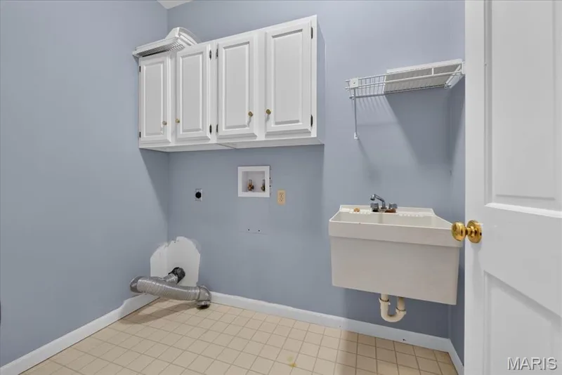 Main floor laundry room with sink and cabinets. — 14620 Timberlake Manor Court, Chesterfield, MO 63017