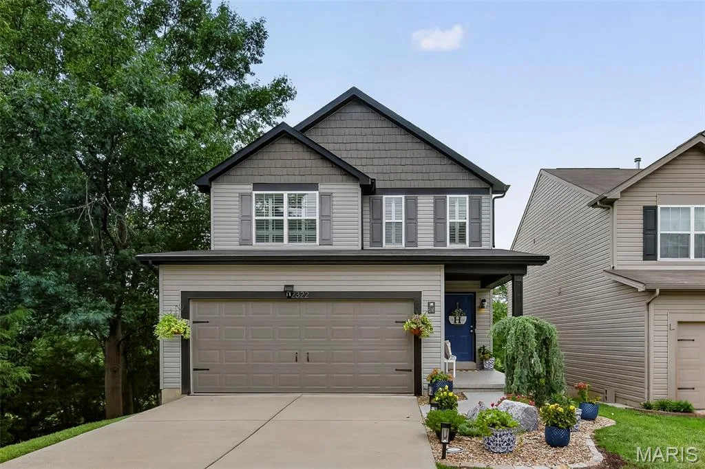 Front Elevation with Shake Accent Siding, Large Front Porch and Colorful Landscape — 2322 Wills Hollow Drive, St Peters, MO 63376