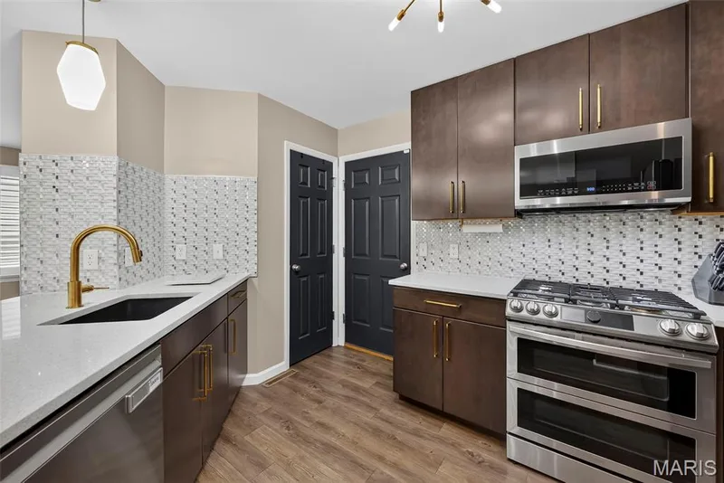 Stainless Steel Appliances, Tile Backsplash, Solid Surface Countertops and Luxury Vinyl Plank Flooring — 2322 Wills Hollow Drive, St Peters, MO 63376