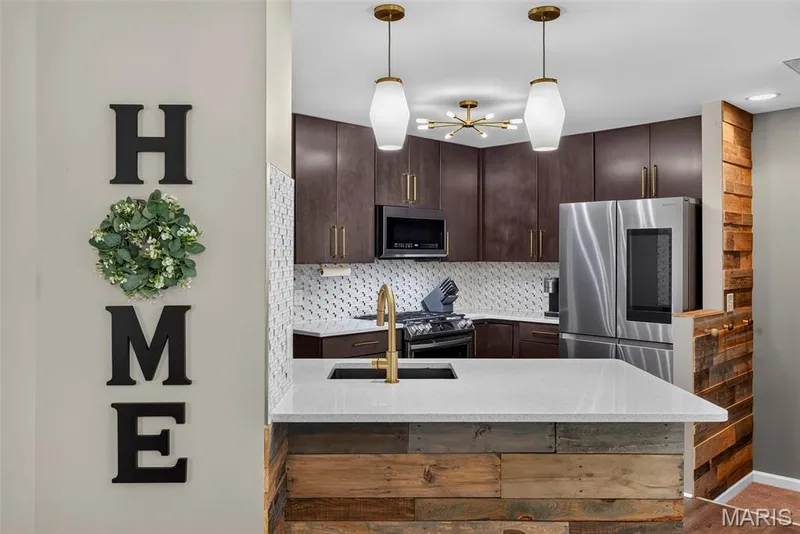 Kitchen with Seating Bar and Solid Surface Countertops — 2322 Wills Hollow Drive, St Peters, MO 63376