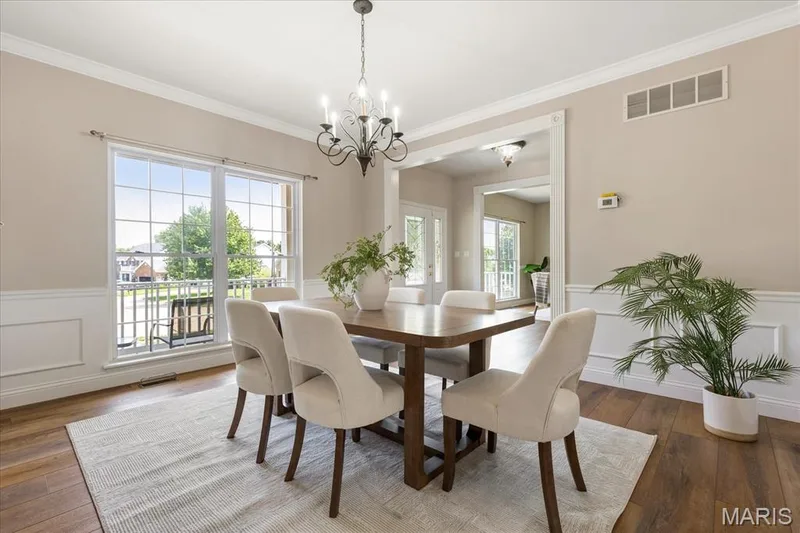 Spacious open-concept dining room flowing seamlessly into adjacent main-floor living and kitchen. — 354 Buckington Street, St Peters, MO 63376