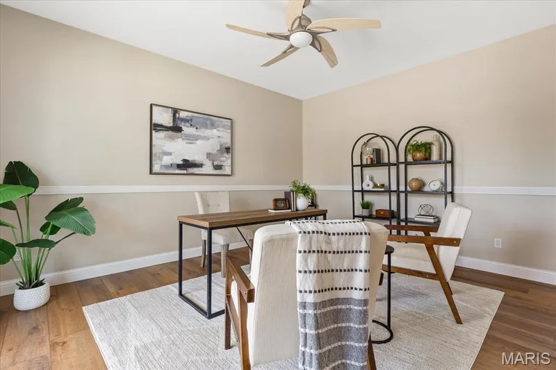 Retreat to a quiet main-level office featuring beautiful luxury vinyl plank flooring and chair railing. — 354 Buckington Street, St Peters, MO 63376