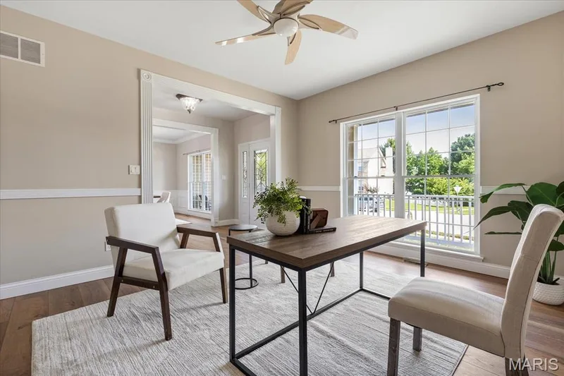 Sun-lit home office with large front-facing windows, elegant door casings, and a seamless connection to the main foyer. — 354 Buckington Street, St Peters, MO 63376