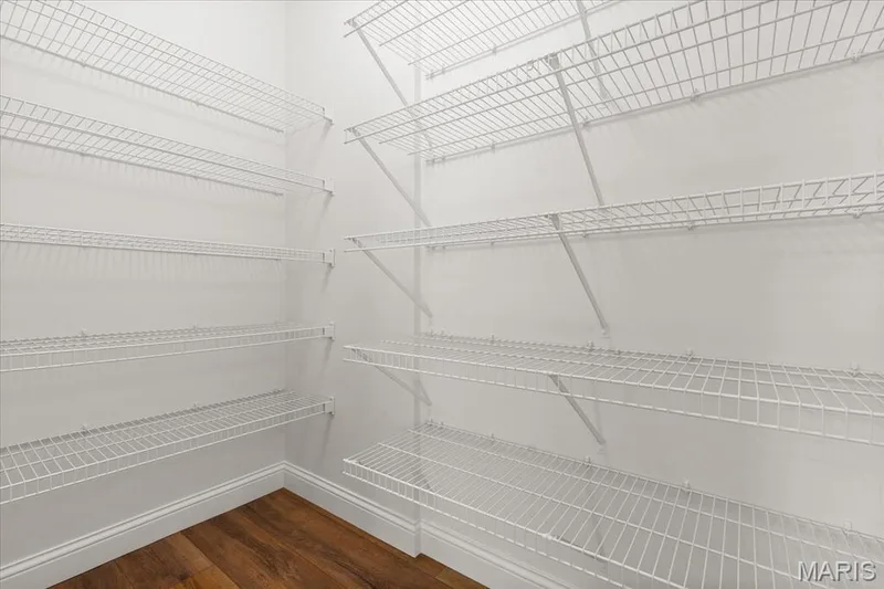 Spacious walk-in pantry equipped with extensive multi-tier wire shelving for optimal storage and organization. — 354 Buckington Street, St Peters, MO 63376