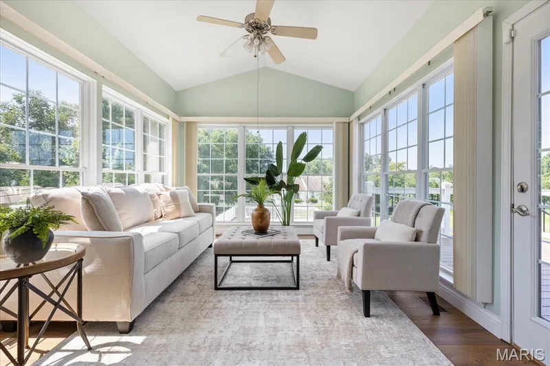 Step into the sunroom, a vaulted, window-wrapped sanctuary perfect for unwinding with backyard views. — 354 Buckington Street, St Peters, MO 63376