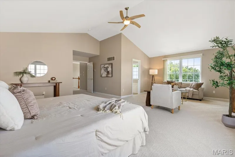 Sprawling and serene, the primary bedroom offers ample space for both a plush king bed and a dedicated private sitting nook. — 354 Buckington Street, St Peters, MO 63376