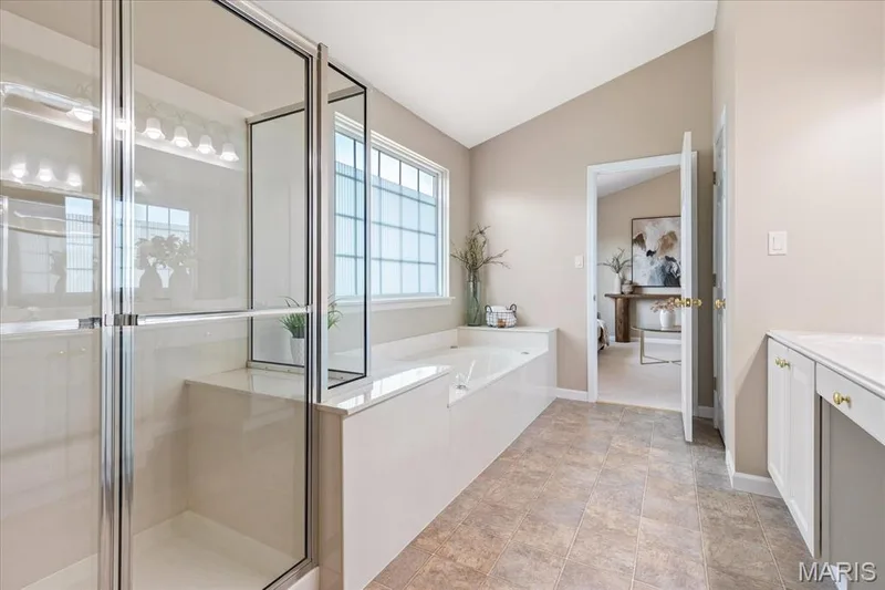 Morning light softly fills the primary ensuite, inviting you to start your day in a clean, spa-inspired atmosphere. — 354 Buckington Street, St Peters, MO 63376