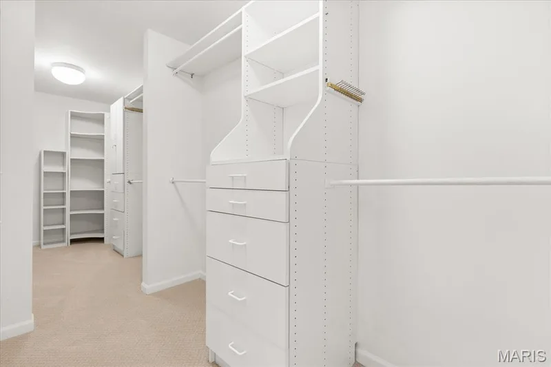 Wardrobe organization becomes a joy thanks to this sprawling walk-in closet complete with custom built-in drawers and shelving. — 354 Buckington Street, St Peters, MO 63376