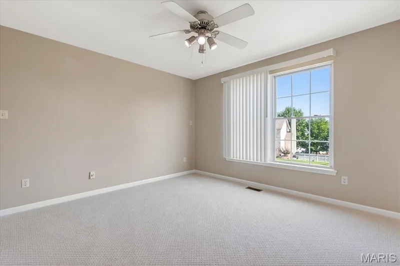 Spacious secondary bedroom with brand-new carpeting, walk-in closet, and tons of natural light with large double-hung window. — 354 Buckington Street, St Peters, MO 63376