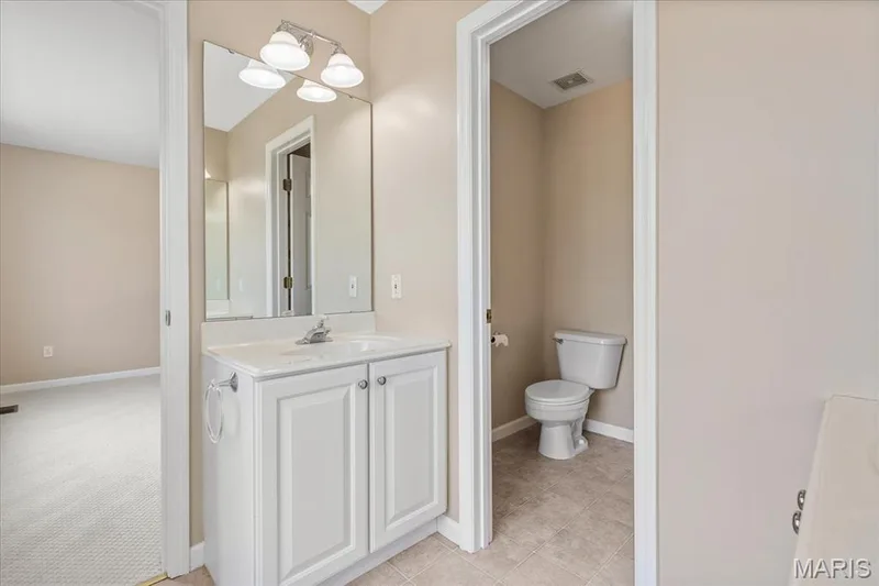 Jack-and-Jill secondary bathroom featuring a separate toilet and shower room. — 354 Buckington Street, St Peters, MO 63376