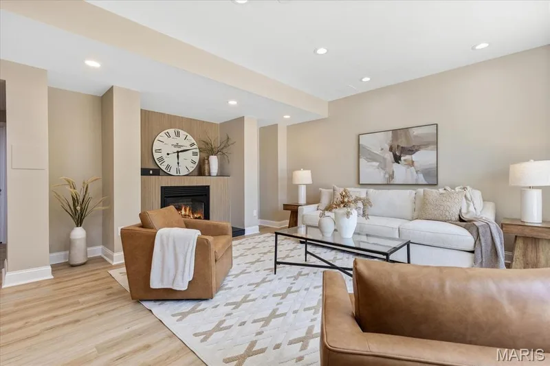 Head downstairs to discover a recently and professionally finished walk-out lower level with brand-new luxury vinyl plank flooring throughout. This beautiful lower level family room is centered around a modern tile-surround fireplace with built-in mantel detail. — 354 Buckington Street, St Peters, MO 63376