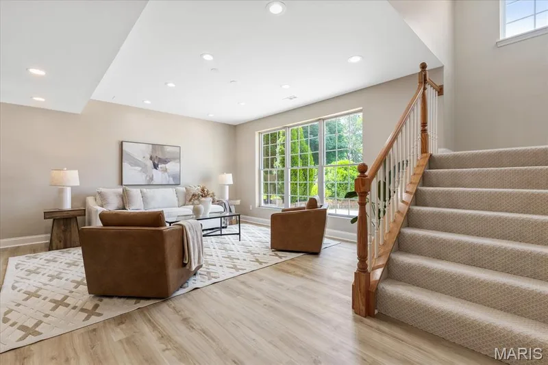 Lower level family room features an impressive wall of floor-to-ceiling multi-pane windows that flood the entire space with rich natural light. — 354 Buckington Street, St Peters, MO 63376