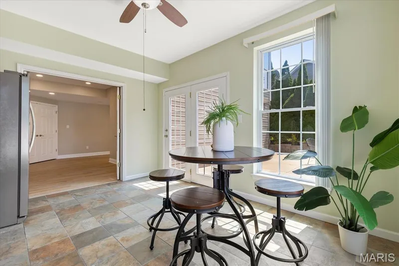 Grab snacks or cold drinks from the kitchenette before stepping straight out through French doors to the patio and pool. — 354 Buckington Street, St Peters, MO 63376