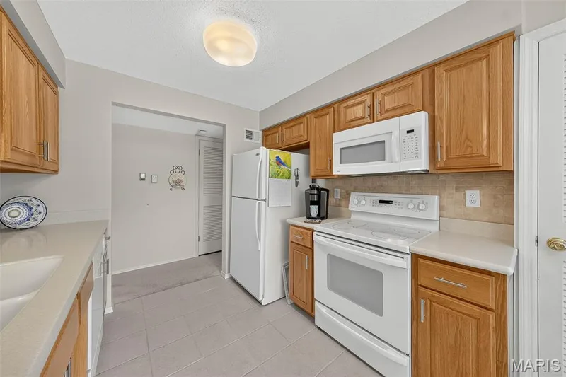 Kitchen with Electric Range and Refrigerator Included — 1530 Bedford Forge Court #15, Chesterfield, MO 63017
