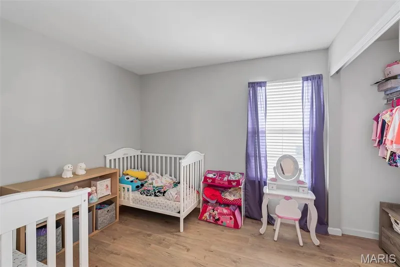 Light gray walls with wood-finish flooring — 640 Homerun Drive #37N, O'Fallon, MO 63366