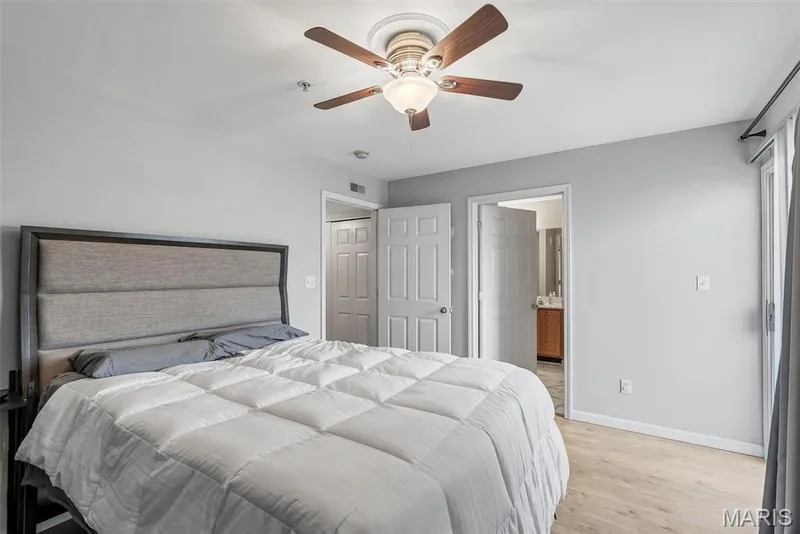 Bedroom featuring light wood-finish flooring and a ceiling fan with integrated lighting — 640 Homerun Drive #37N, O'Fallon, MO 63366