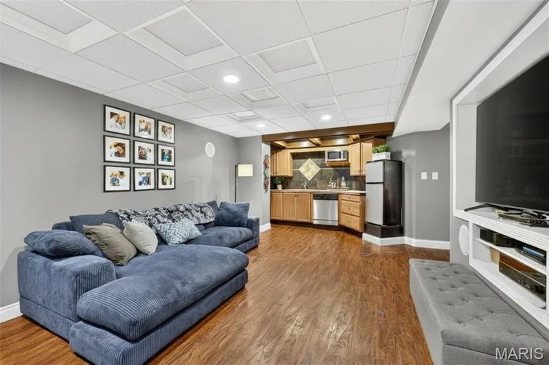 Recreational room featuring wood-finish flooring, recessed lighting, and a built-in entertainment center — 708 Woodland Ridge Drive, St Peters, MO 63376