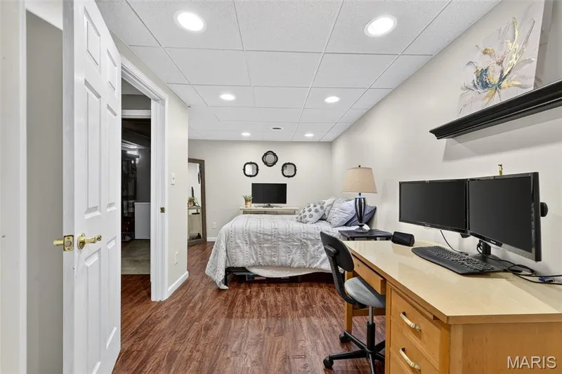 Wood-finish flooring, recessed lighting, white panel doors, and a drop ceiling — 708 Woodland Ridge Drive, St Peters, MO 63376