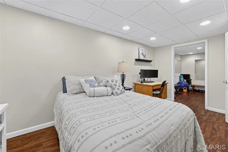 Recessed lighting, wood-finish flooring, drop ceiling, light-toned wall paint, and an open doorway — 708 Woodland Ridge Drive, St Peters, MO 63376
