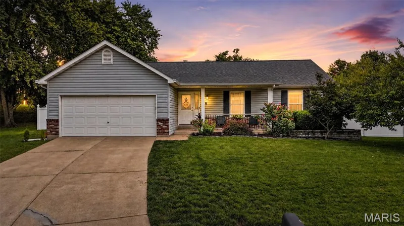 Gray siding exterior with a dark shingle roof — 708 Woodland Ridge Drive, St Peters, MO 63376