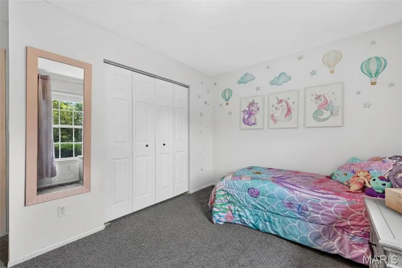 White walls, grey carpeting, and white bi-fold closet doors — 708 Woodland Ridge Drive, St Peters, MO 63376