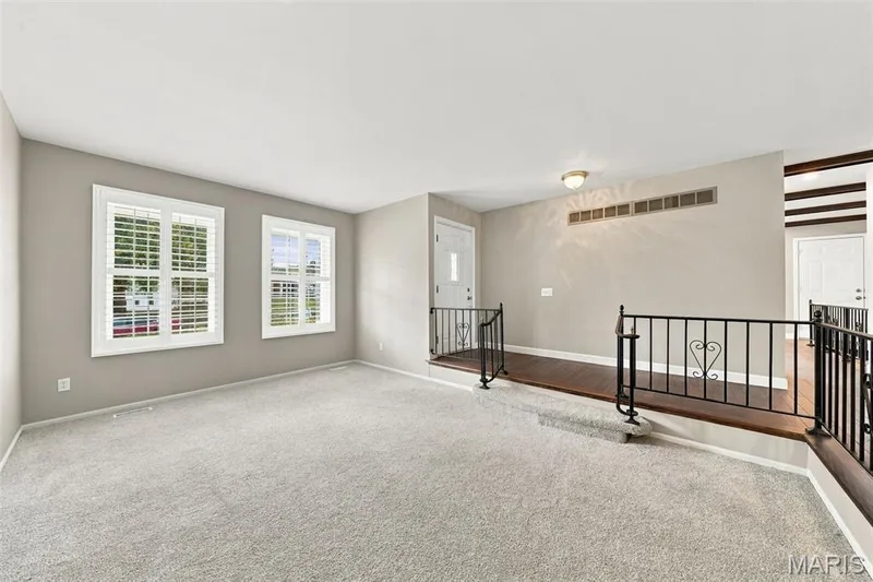 Sunlit living room has newer  carpeting and large windows — 1230 Luray Drive, Chesterfield, MO 63017