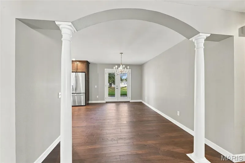 The dining room with it's welcoming pineapple chandelier opens to the kitchen, patio and living room — 1230 Luray Drive, Chesterfield, MO 63017