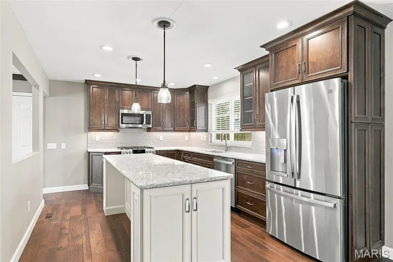 Chef's delight kitchen has tons of cabinets, countertop, a breakfast bar island and so much more! — 1230 Luray Drive, Chesterfield, MO 63017