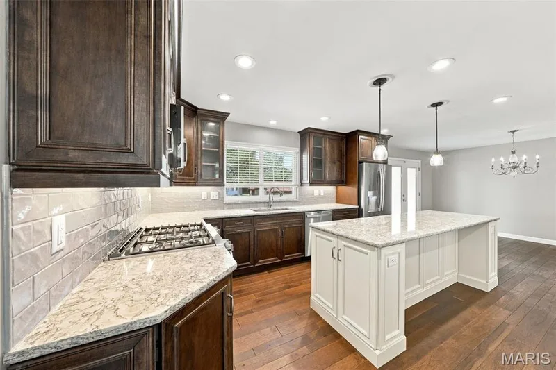 from warm under-cabinet lighting to the fabulous gas range, this kitchen is built for both holiday entertaining and everyday life — 1230 Luray Drive, Chesterfield, MO 63017